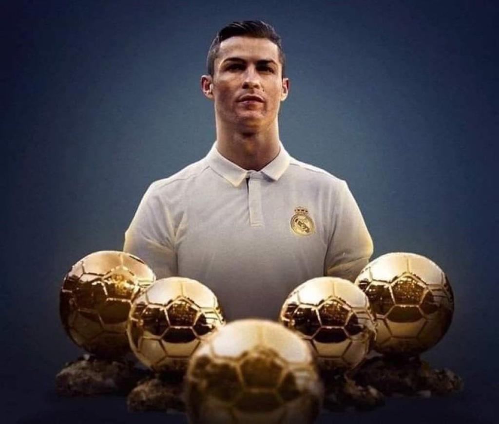 Cristiano Ronaldo standing behind his five Ballon d'Or trophies