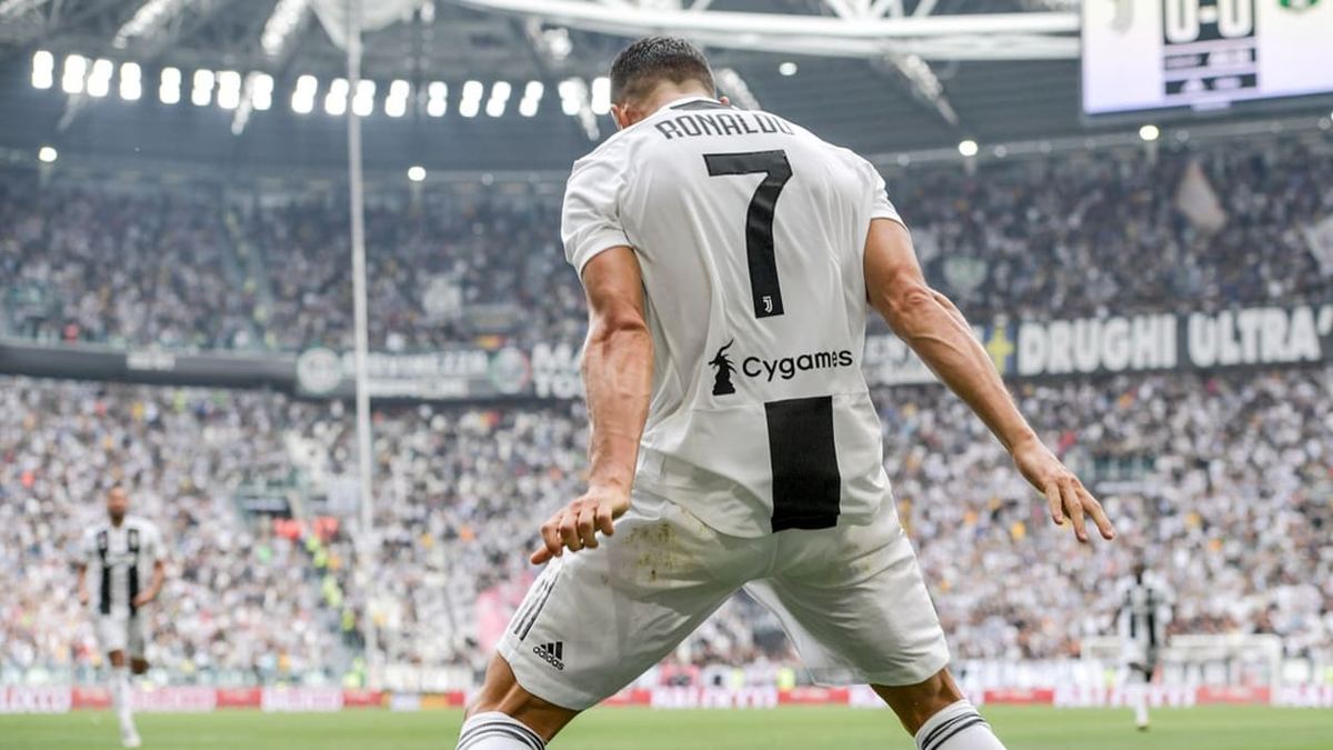 Cristiano Ronaldo celebrates in the Juventus number 7 shirt in front of a full stadium