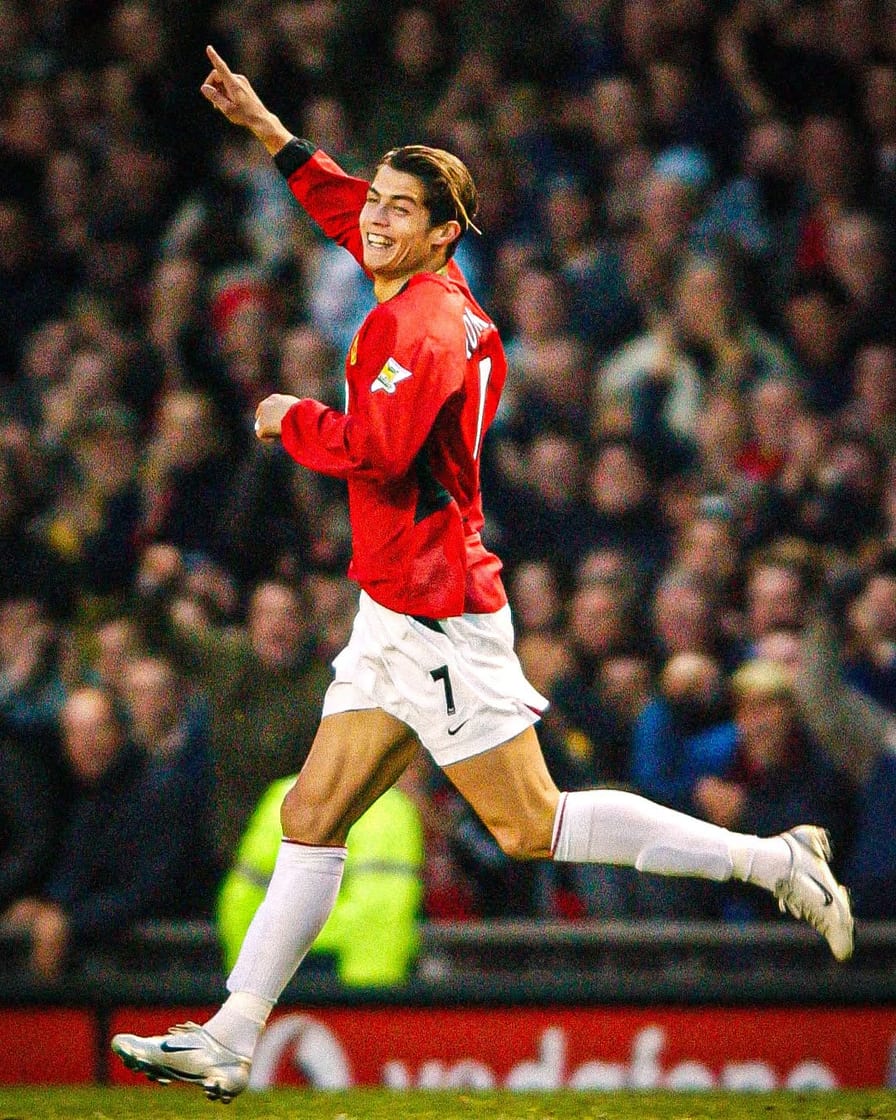 Cristiano Ronaldo wheeling away in the number 7 shirt to celebrate a goal for Manchester United at Old Trafford