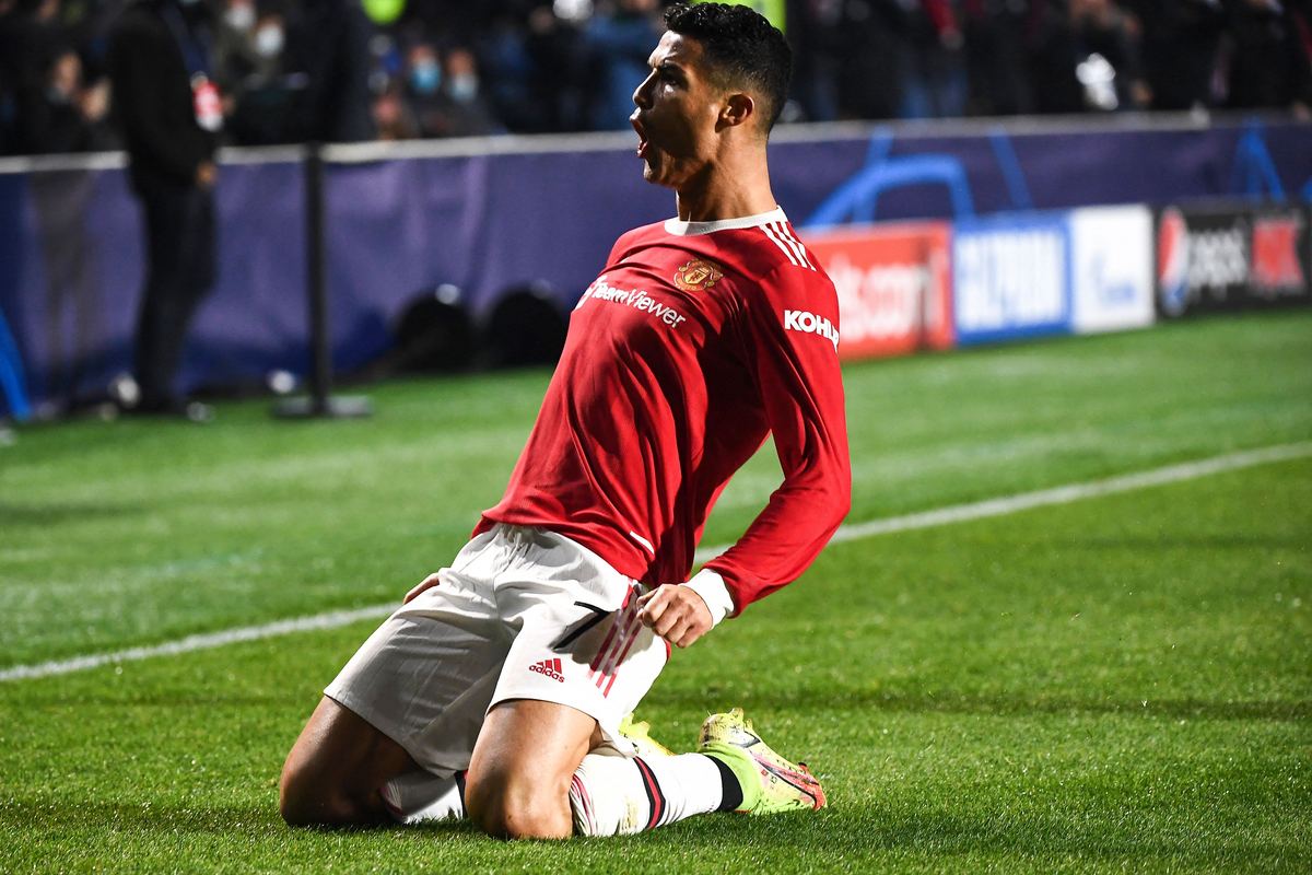 Cristiano Ronaldo slides on his knees celebrating a goal for Manchester United
